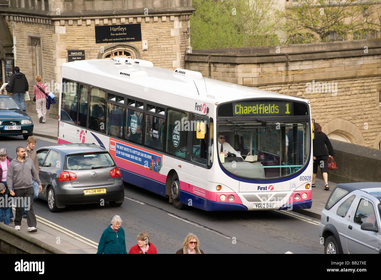 Single decker bus in first group livery driving through York city centre in England Stock Photo