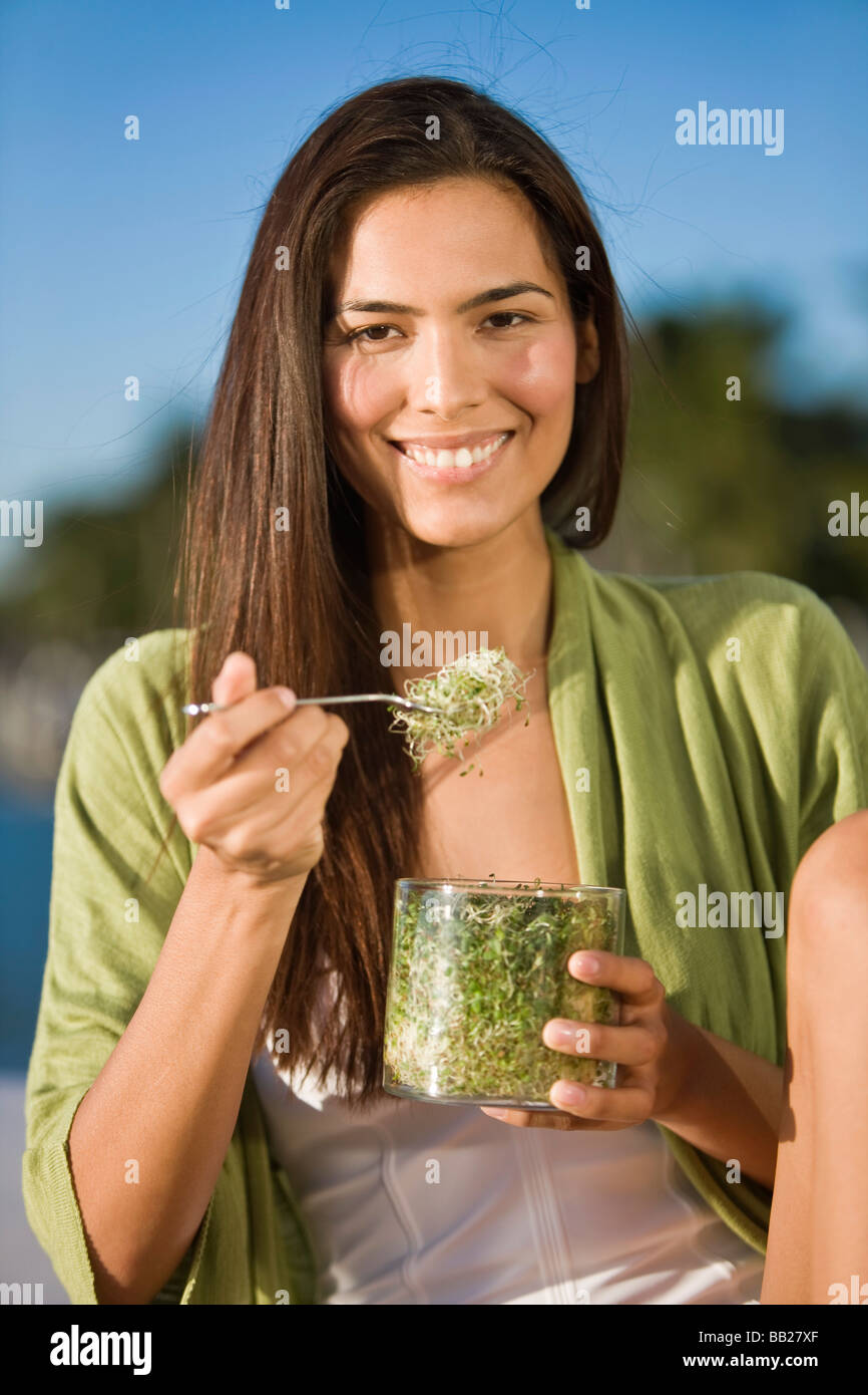 Woman eating bean sprouts Stock Photo Alamy