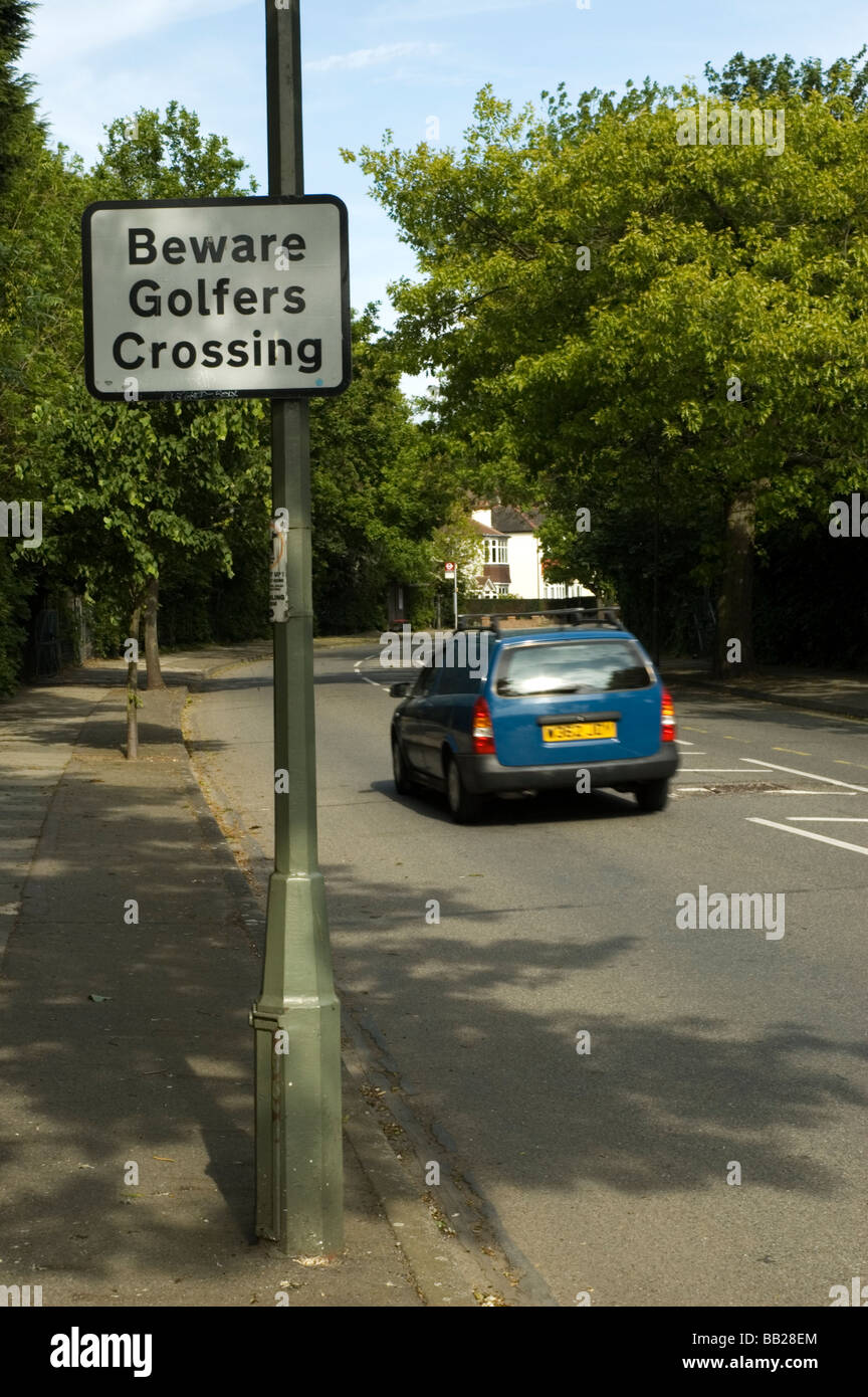 A road sign warns approaching traffic of golfers crossing a suburban road between two sections of Shortlands Golf Course Stock Photo