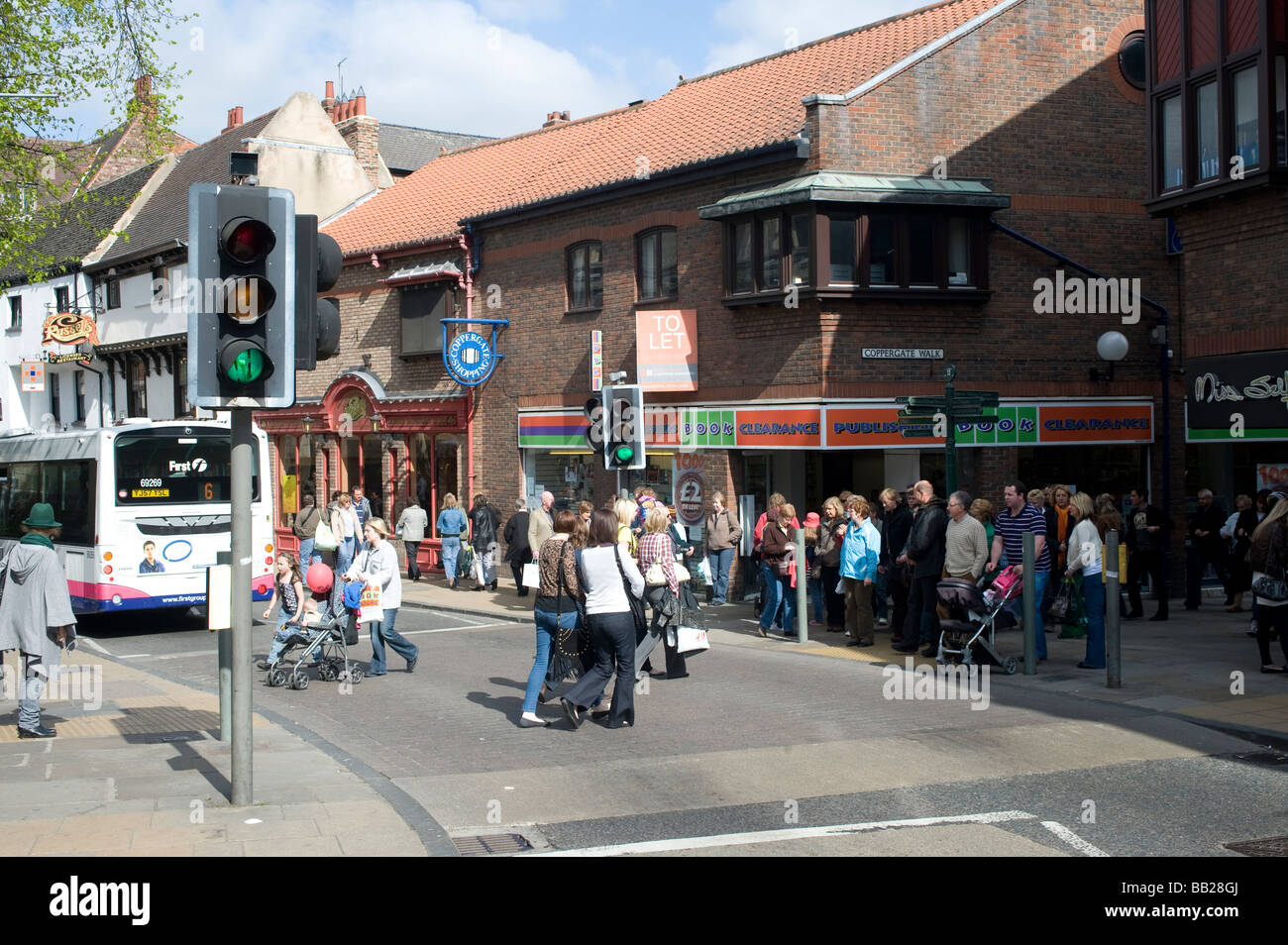 Pedestrians using a pedestrian crossing to cross the road while the ...