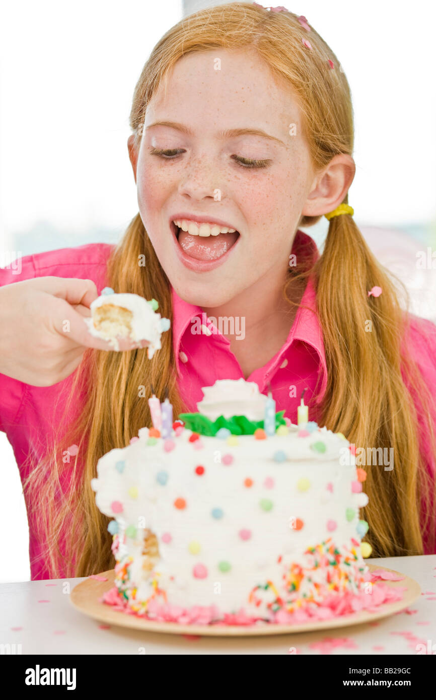 Girl eating birthday cake Stock Photo Alamy