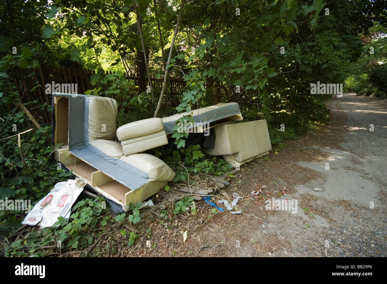 Fly-tipped rubbish beside a country road. Stock Photo