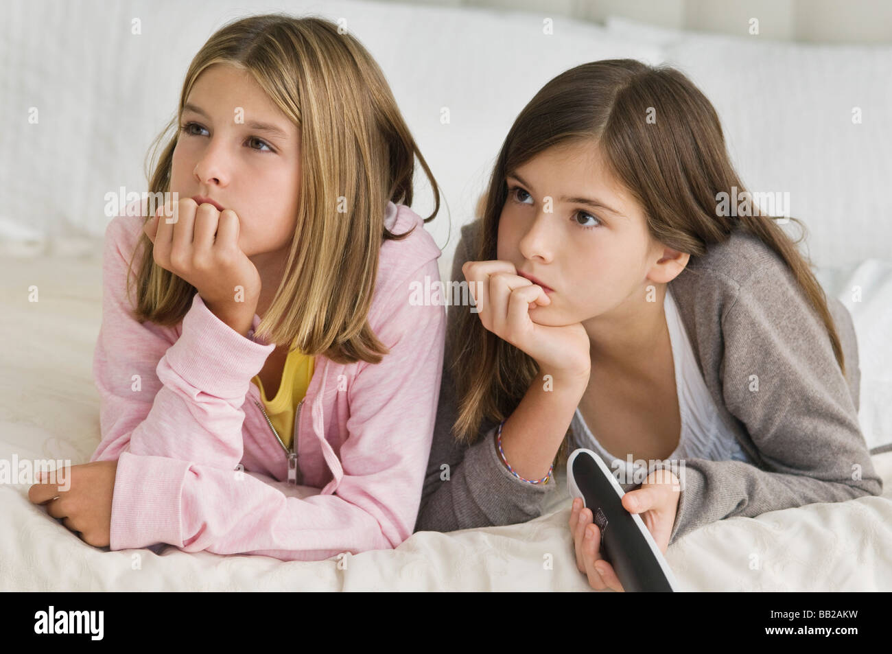 Two girls watching television Stock Photo Alamy