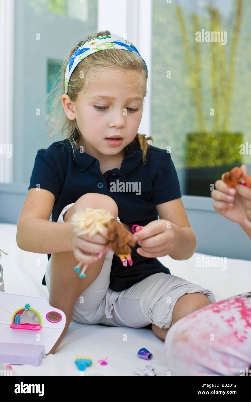 Girl playing with toys Stock Photo - Alamy