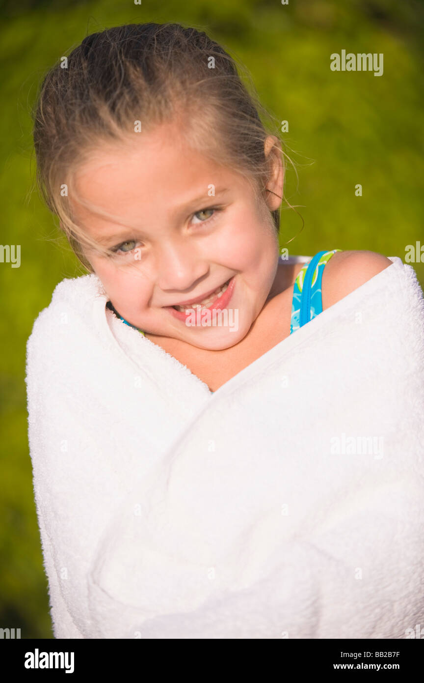 Portrait of a girl wrapped in a towel and smiling Stock Photo - Alamy