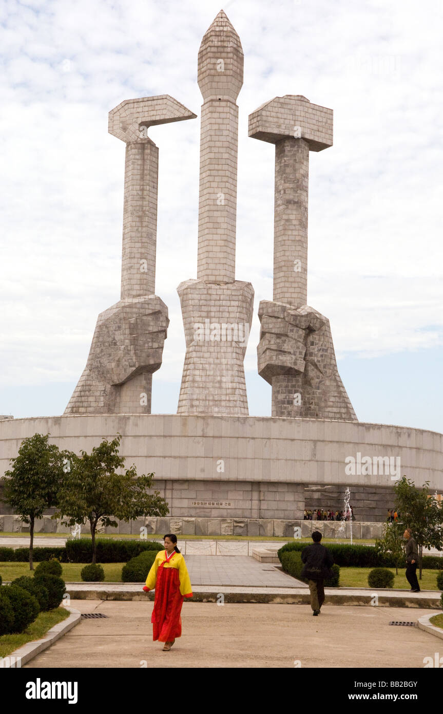 Members of the Korean s workers party are educated at the Monument to Party Foundation which is hands holding a hammer a hoe Stock Photo