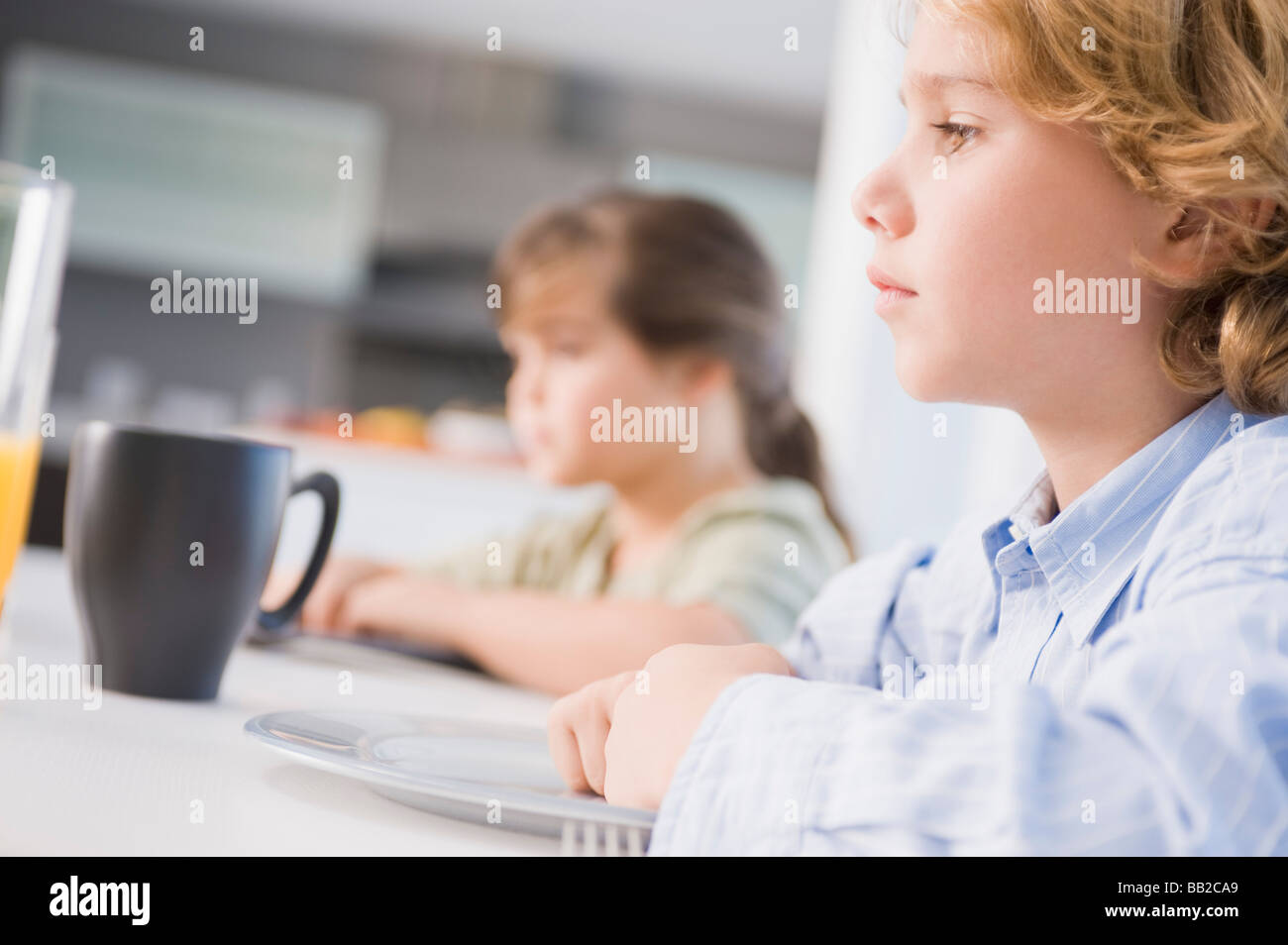 Boy girl sitting table hi-res stock photography and images - Alamy