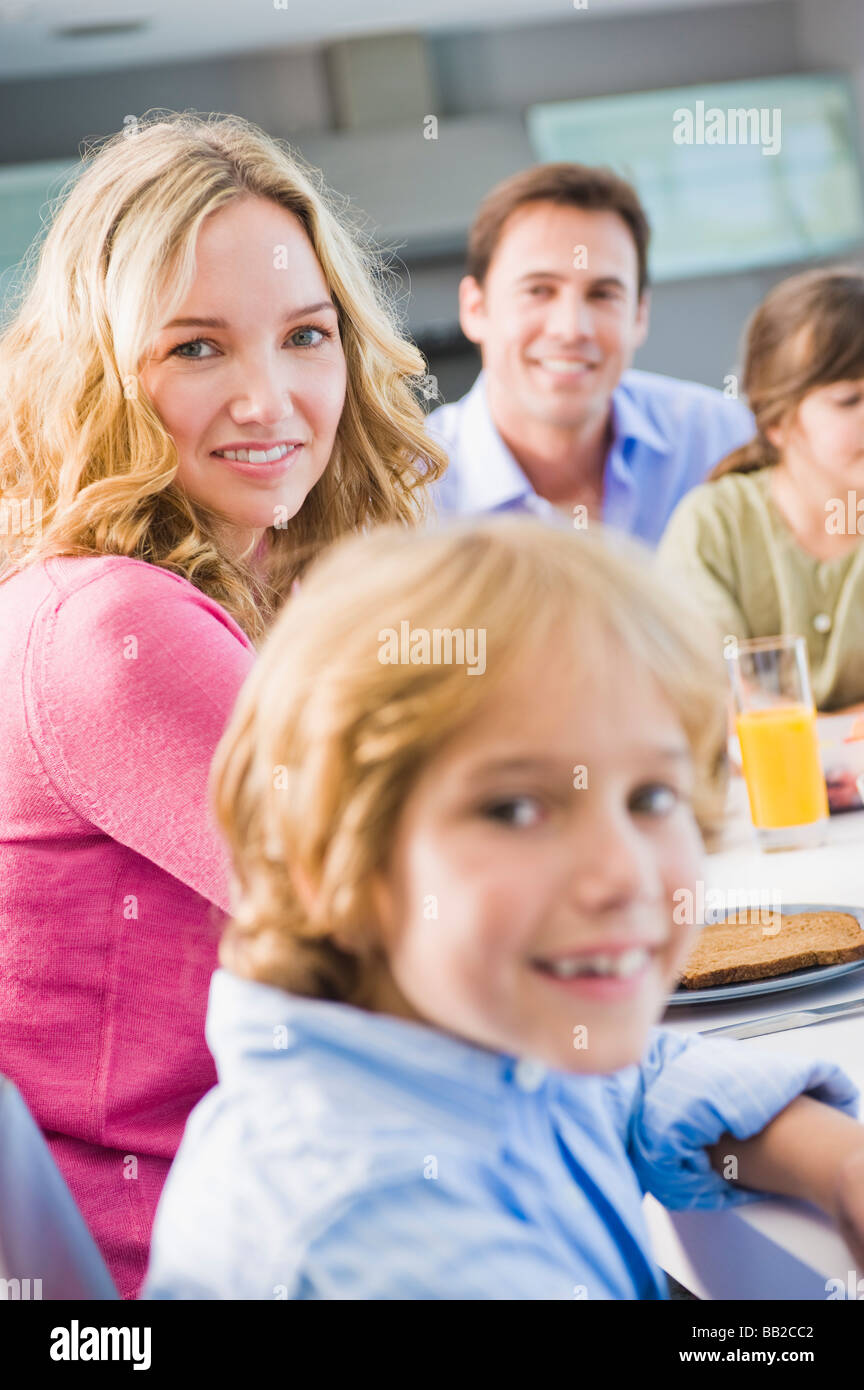 Portrait of a family having breakfast and smiling Stock Photo - Alamy