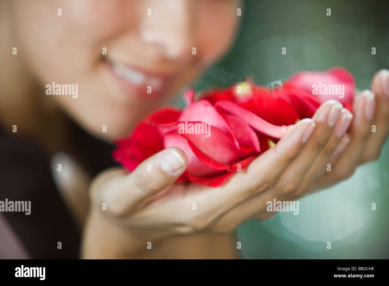 Woman smelling rose flowers Stock Photo Alamy