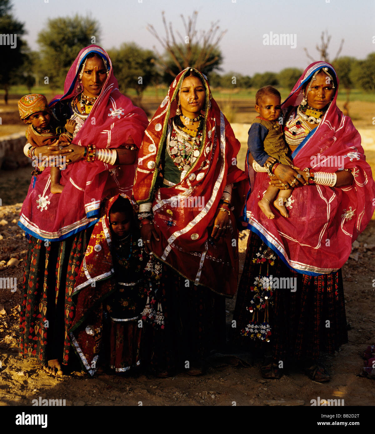Three Indian  Banjara woman in traditional costume with their little children Stock Photo