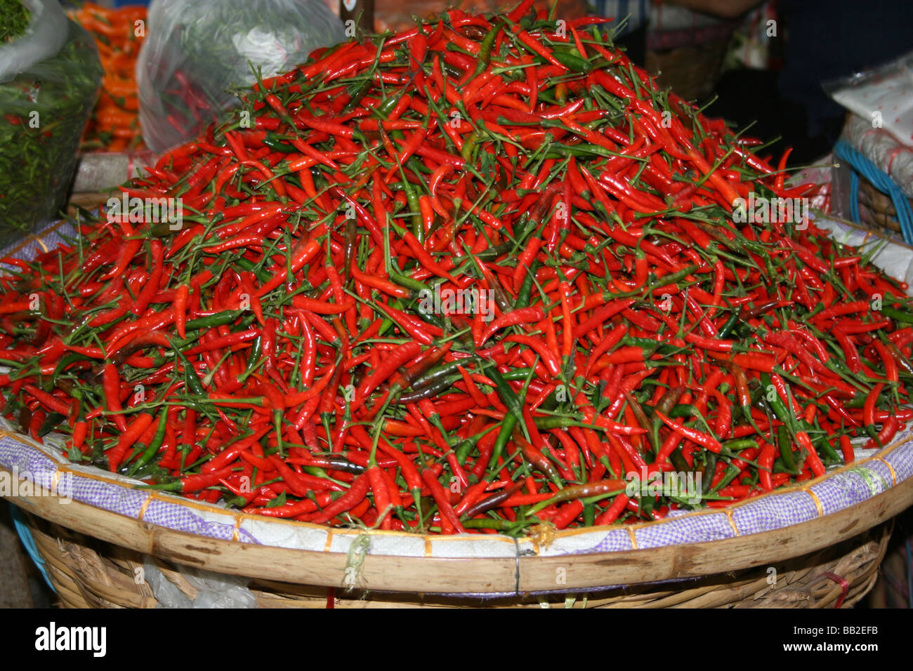 A large pile of red a green chillies at a market in Bankok Stock Photo