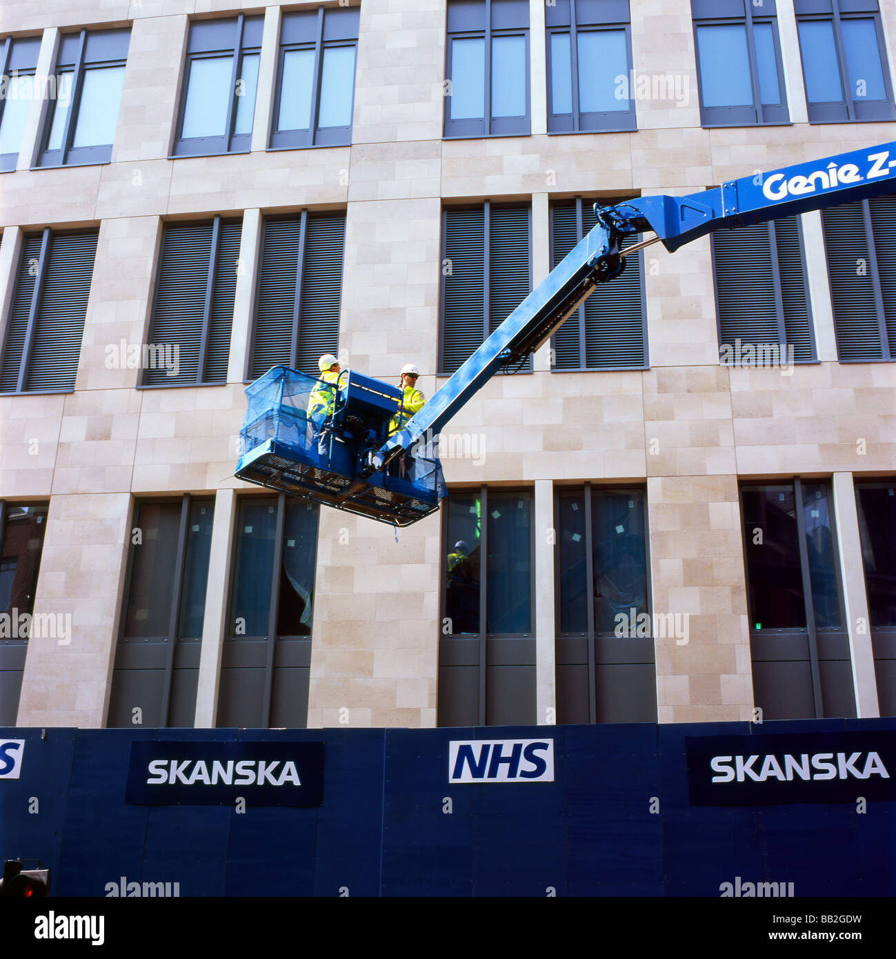 St Barts NHS Cancer Care construction site, Skanska workers in crane lift  and sign London England UK  KATHY DEWITT Stock Photo