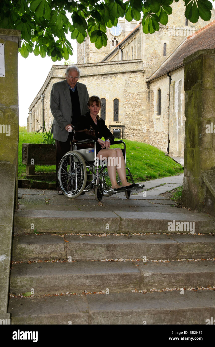 Wheelchair user and carer at the top of a flight of steps Stock Photo Alamy