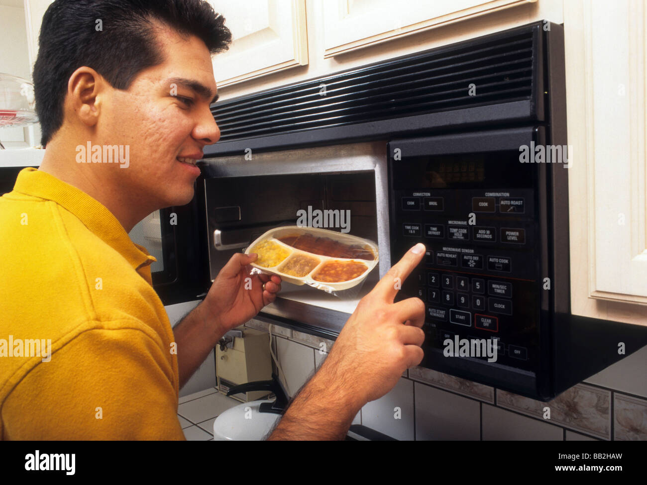 Man cook microwave oven food hot remove Stock Photo Alamy
