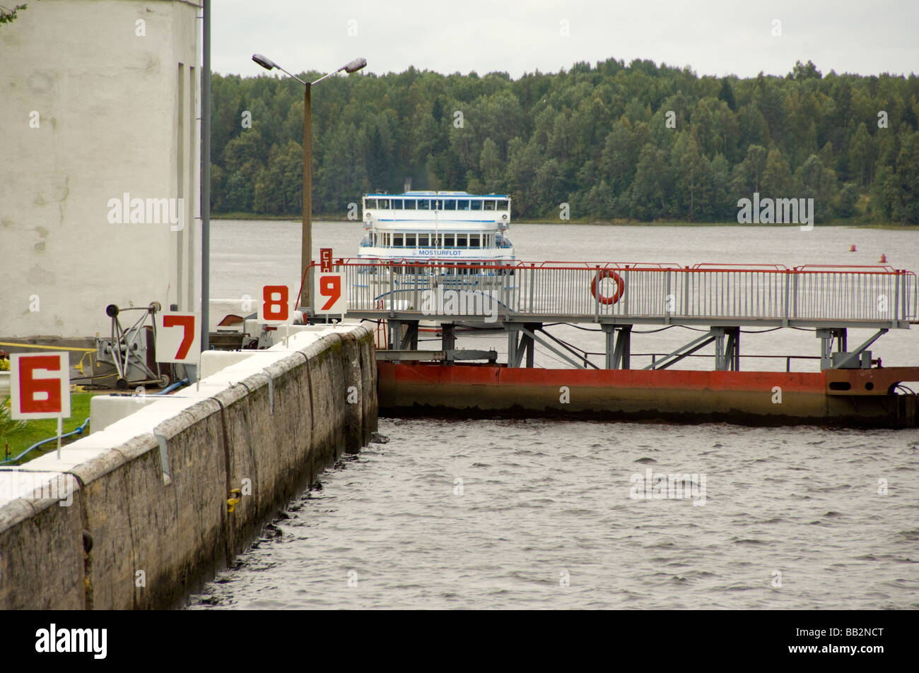 Russia, Svir River (aka The Blue Route), lock area. Riverboat waiting to enter lock. Stock Photo