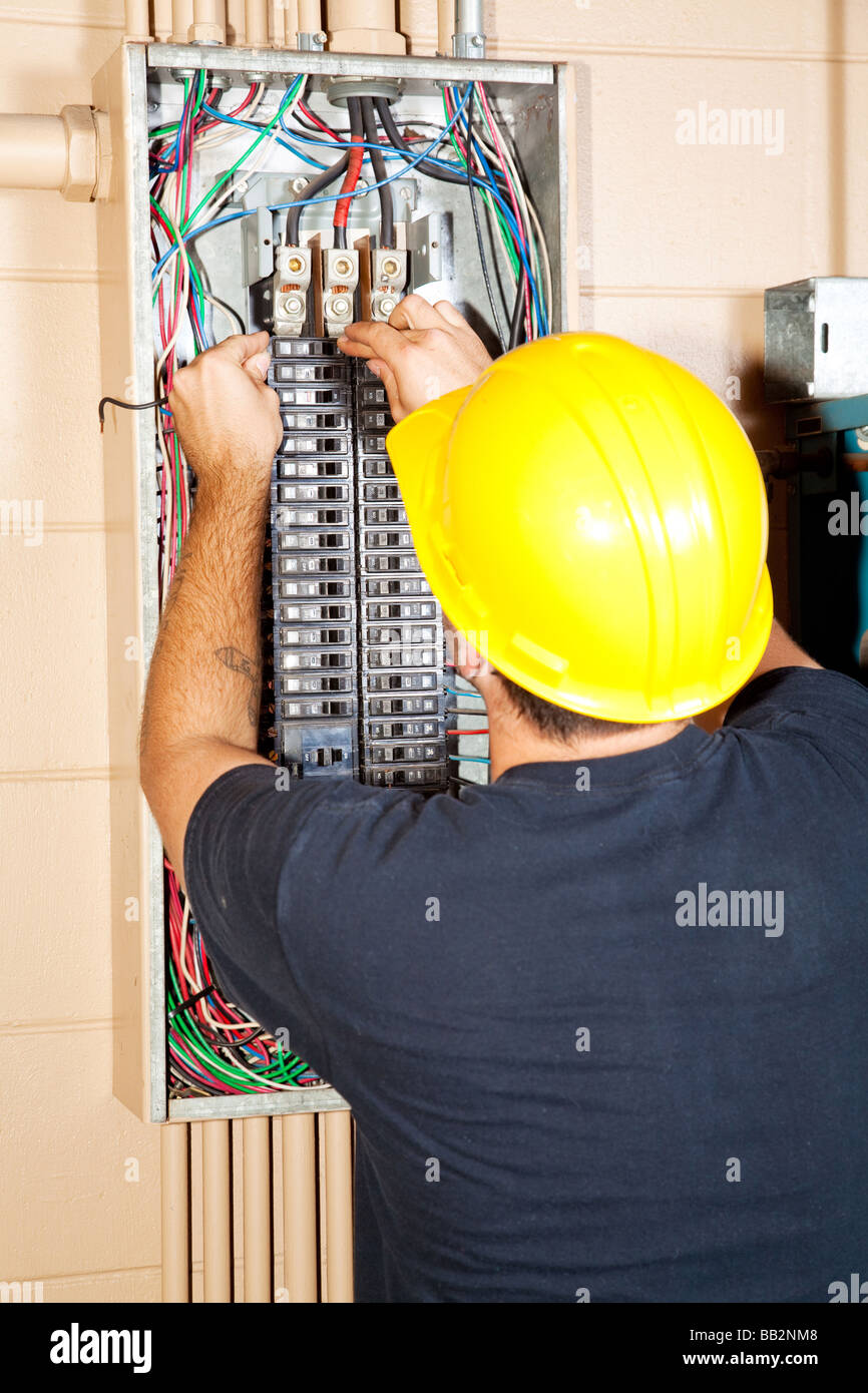 Electrician replacing a bad circuit breaker in a large industrial panel