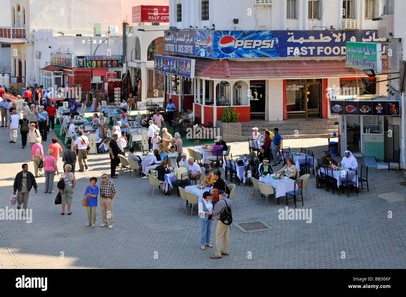 Muttrah Muscat pavemnt area beside the entrance to the Souk with outdoor eating facilities Stock Photo