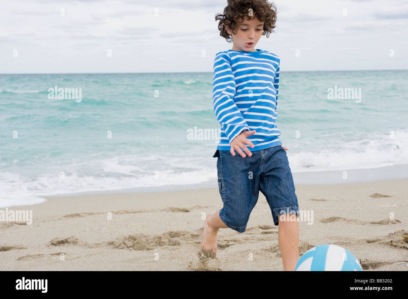 Boy playing on the beach Stock Photo - Alamy