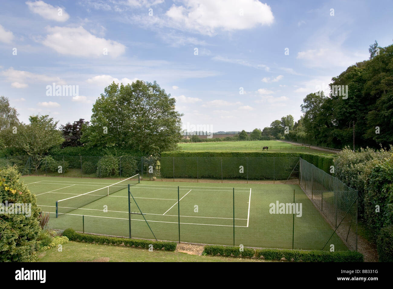 UK. A garden with a private tennis court Stock Photo Alamy