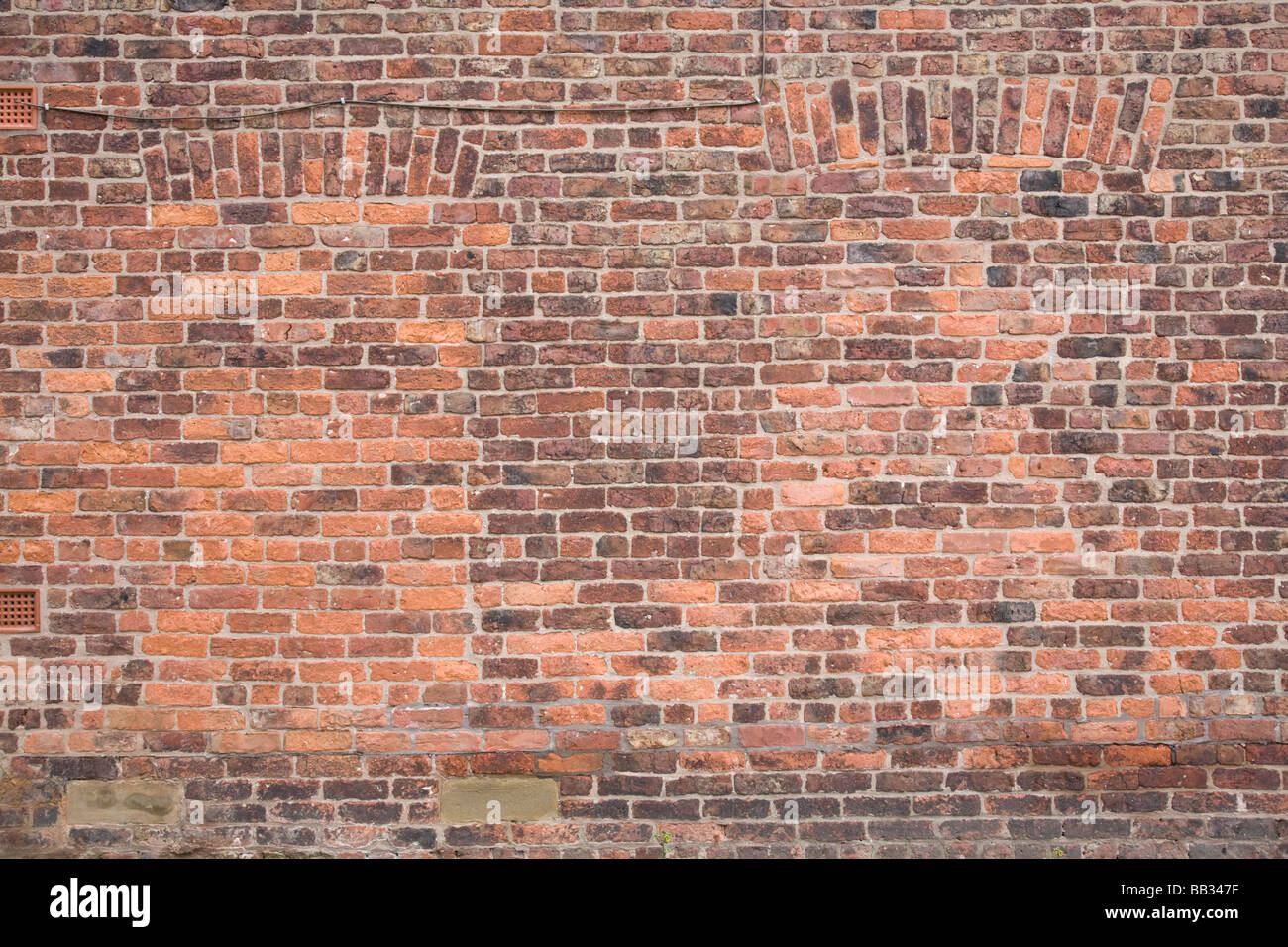 Brick wall with bricked up windows. Styal, Cheshire, United Kingdom. Stock Photo
