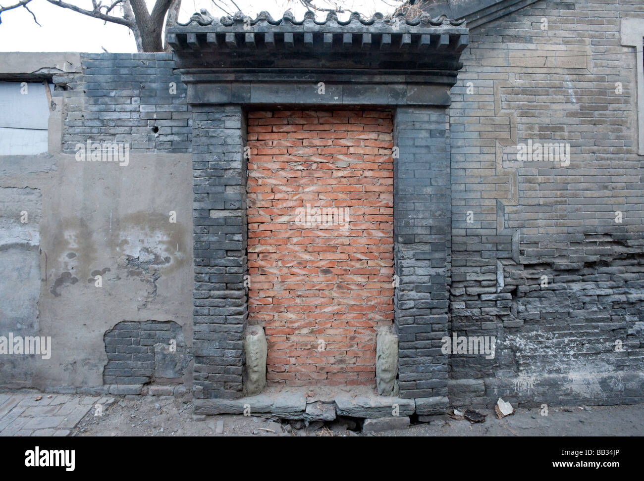 Historic traditional doorway to house in Beijing hutong bricked up prior to demolition in area undergoing redevelopment Stock Photo