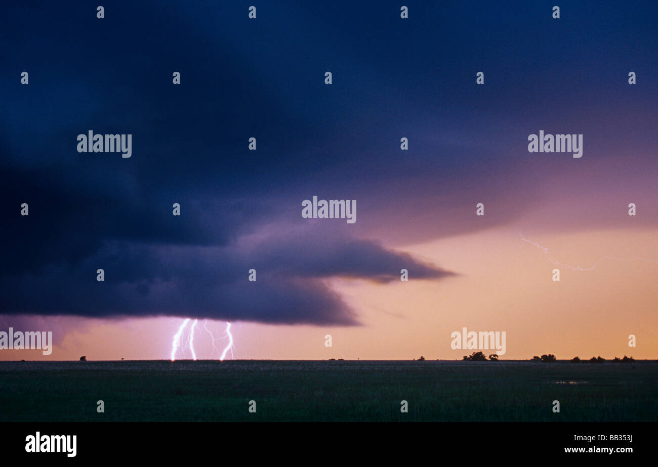 Lightning below the inflow area of a supercell thunderstorm at dusk in Oklahoma, USA Stock Photo