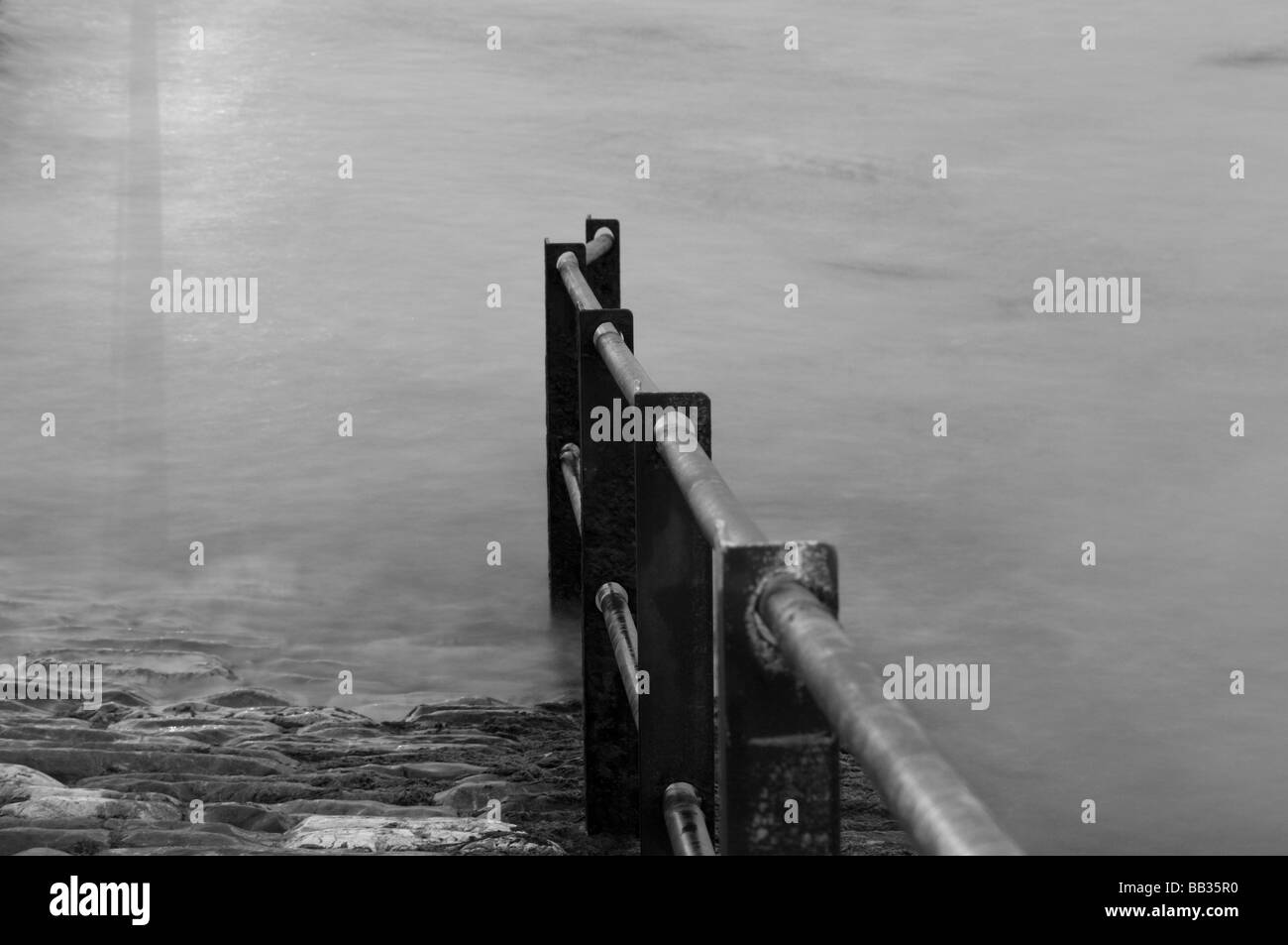 black and white picture of railings into the sea Stock Photo - Alamy