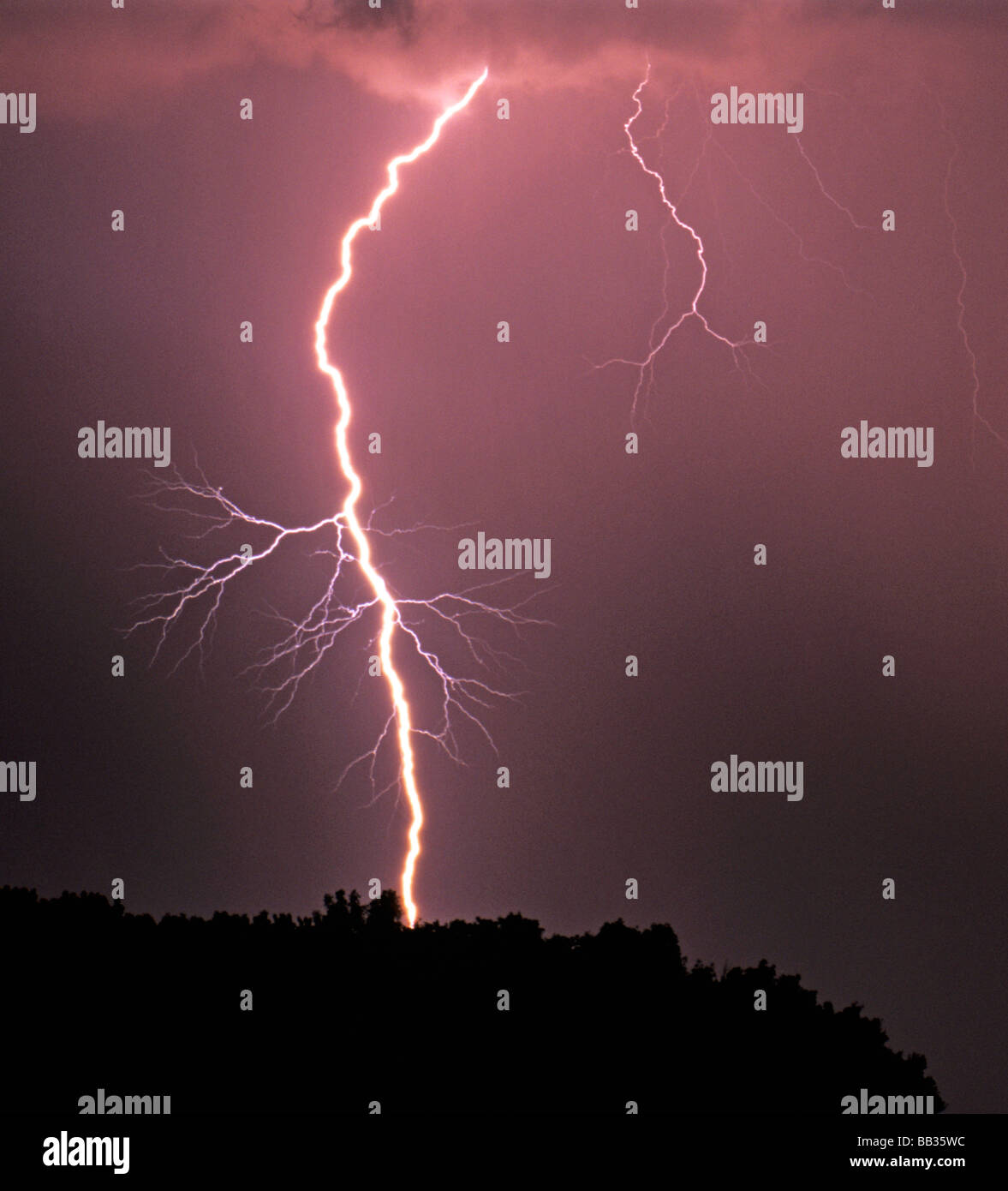 A cloud to ground lightning strike during a severe thunderstorm near