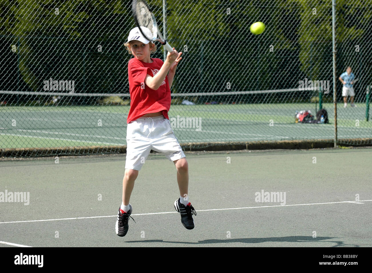 A nine year old boy playing tennis Stock Photo Alamy