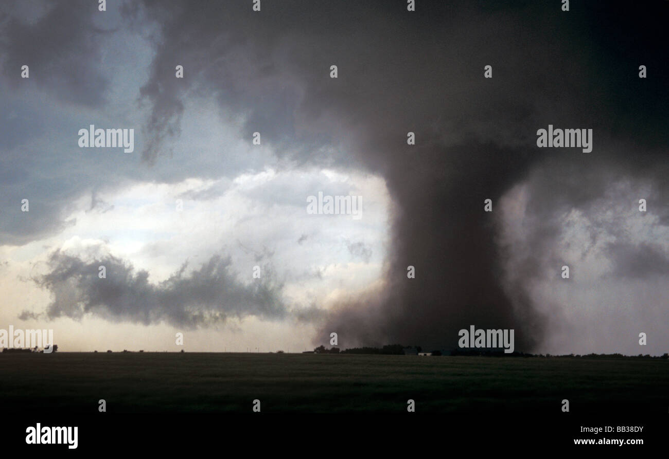 A large dusty tornado bears down on a farmhouse in Nebraska, USA Stock Photo