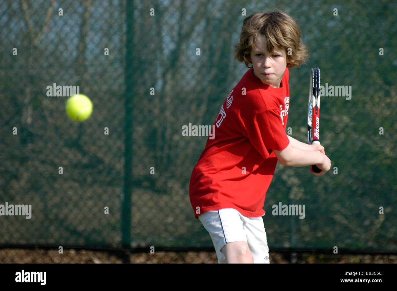 A ten year old boy playing tennis Stock Photo Alamy