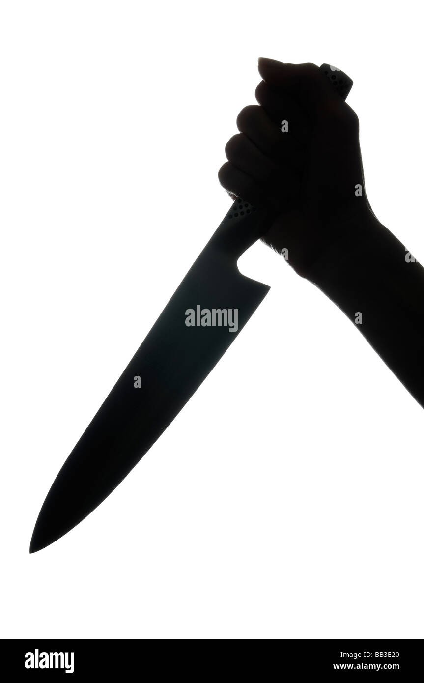 Silhouette of a Hand Holding a Knife Stock Photo