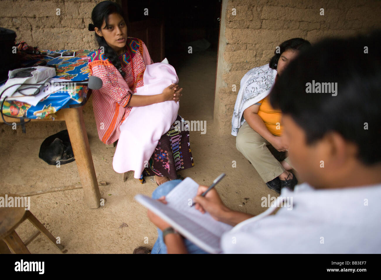 Women with baby giving interview, village of Tacana, Ixtahuacan, Guatemala. Stock Photo