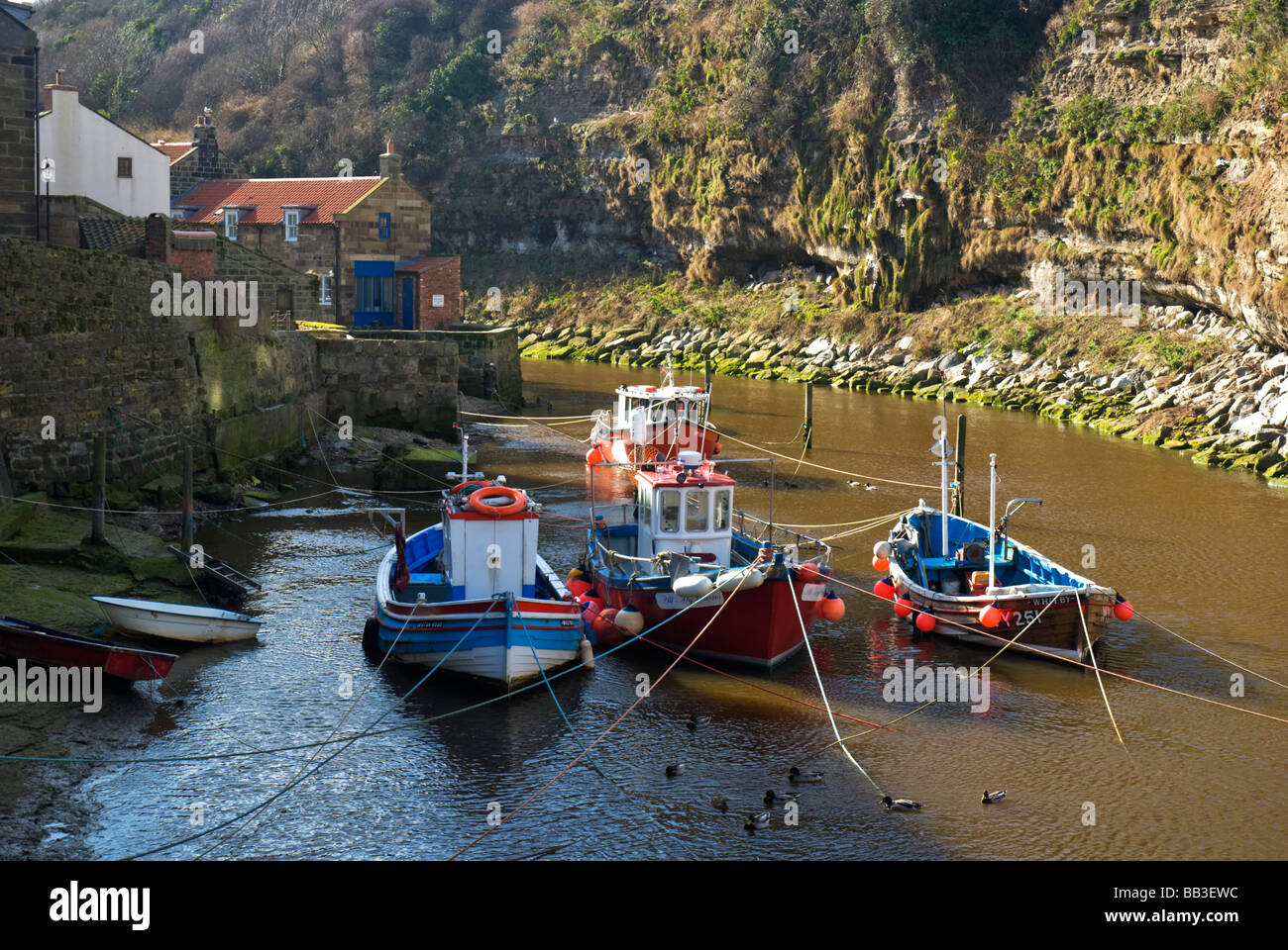 Fishing boats in the harbour at Staithes Yorkshire England Stock Photo