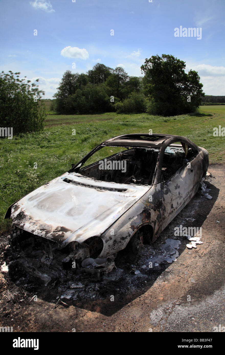 A burnt out shell of a Mercedes Benz Coupe left in rural farmland Stock ...