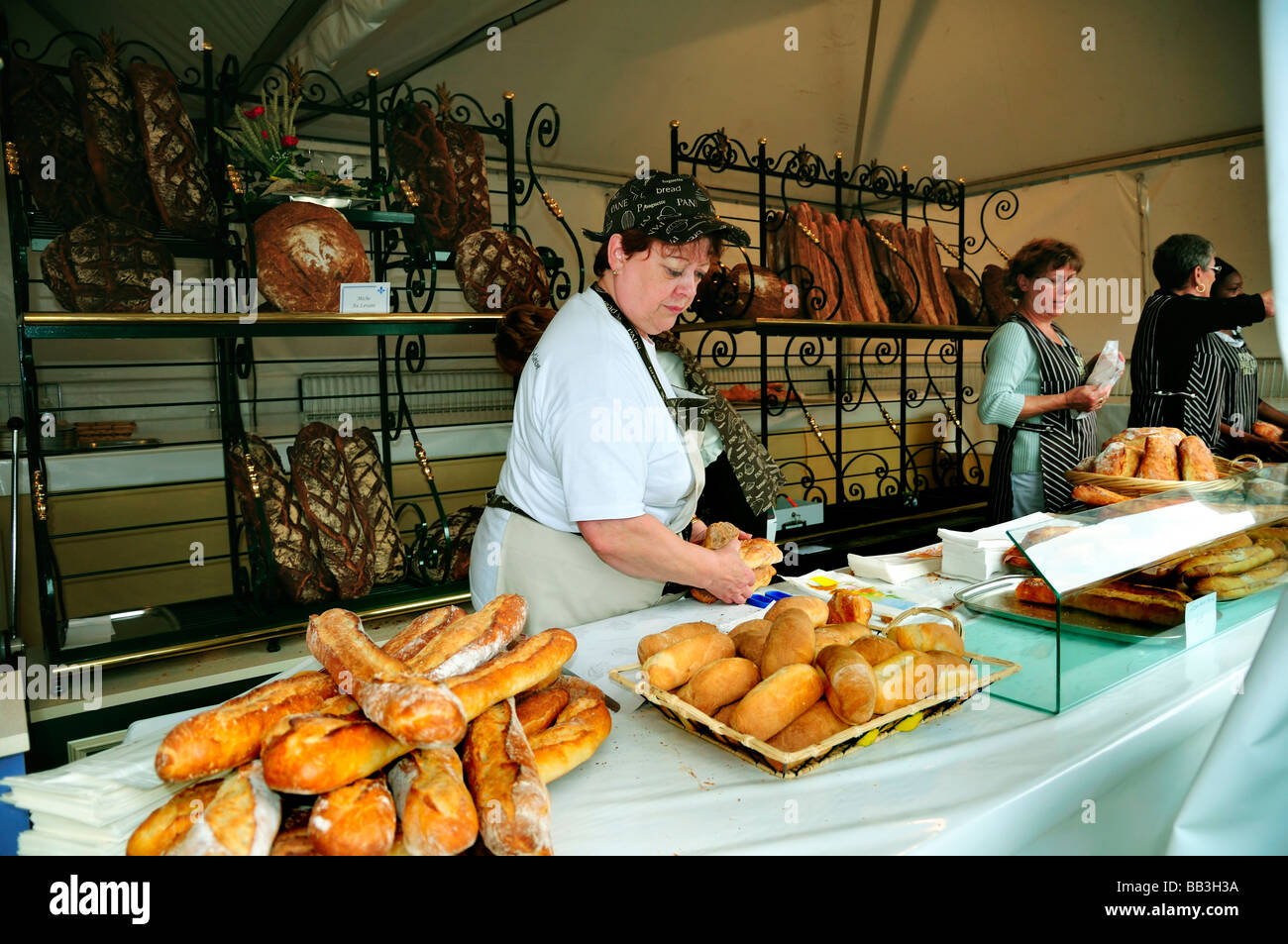 Paris France, French Artisan Bakery Store Inside Female Clerk with French Breads at 'Fete du Pain' 'Bread Festival' baguettes, bakery counter france, Stock Photo