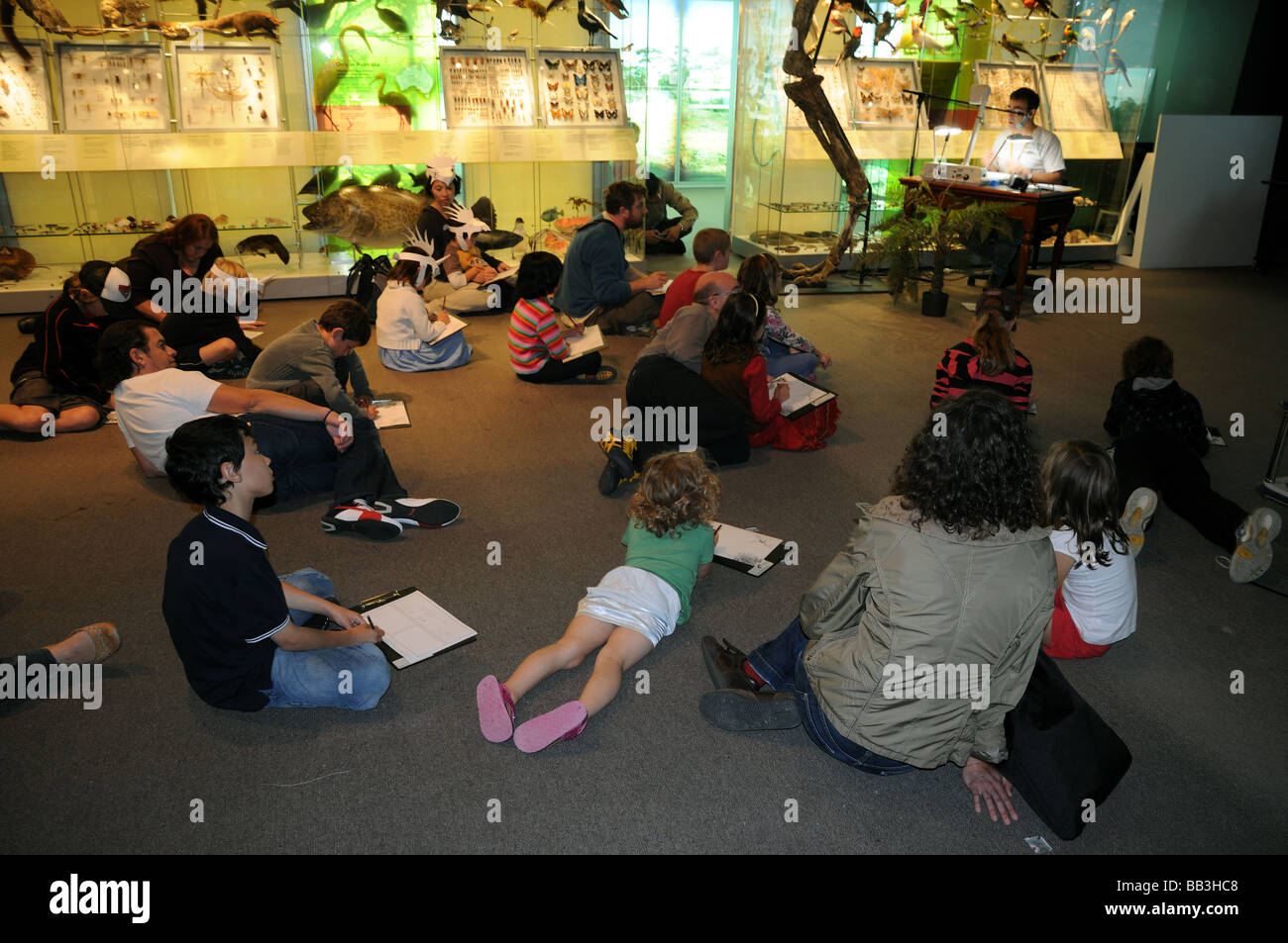 Children and families enjoying an educational lecture inside Melbourne Museum Australia Stock Photo