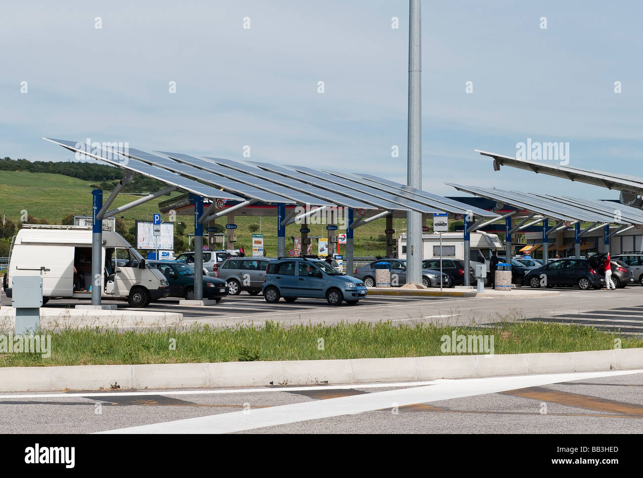 Solar panels used to simultaneously shade parked cars and to generate electricity at an Italian motorway services in Tuscany, Italy Stock Photo