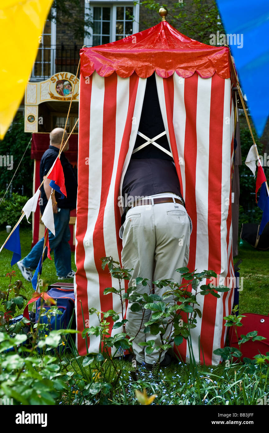 A Professor preparing his booth for a performance of Punch and Judy