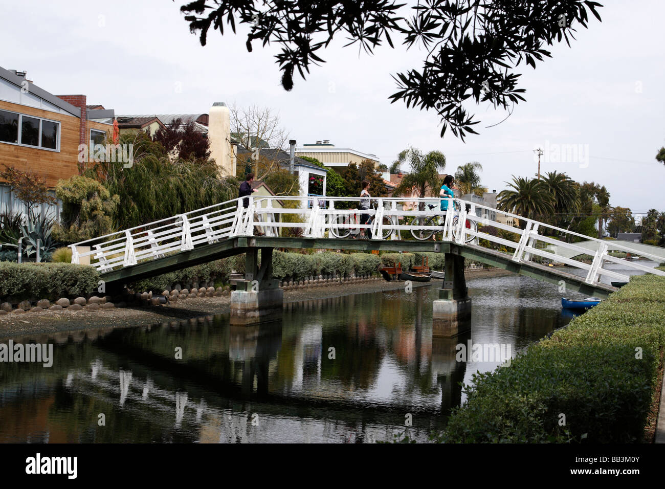people crossing the wooden footbridge over sherman canal venice los angeles california usa Stock Photo