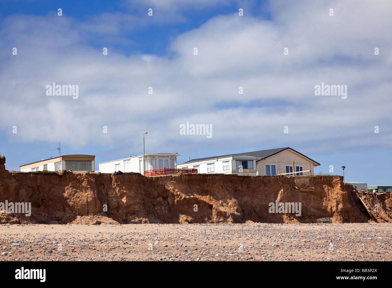 Holiday homes in danger from North Sea coastal erosion on the cliffs of the Holderness Coast, Easington, Yorkshire UK Stock Photo