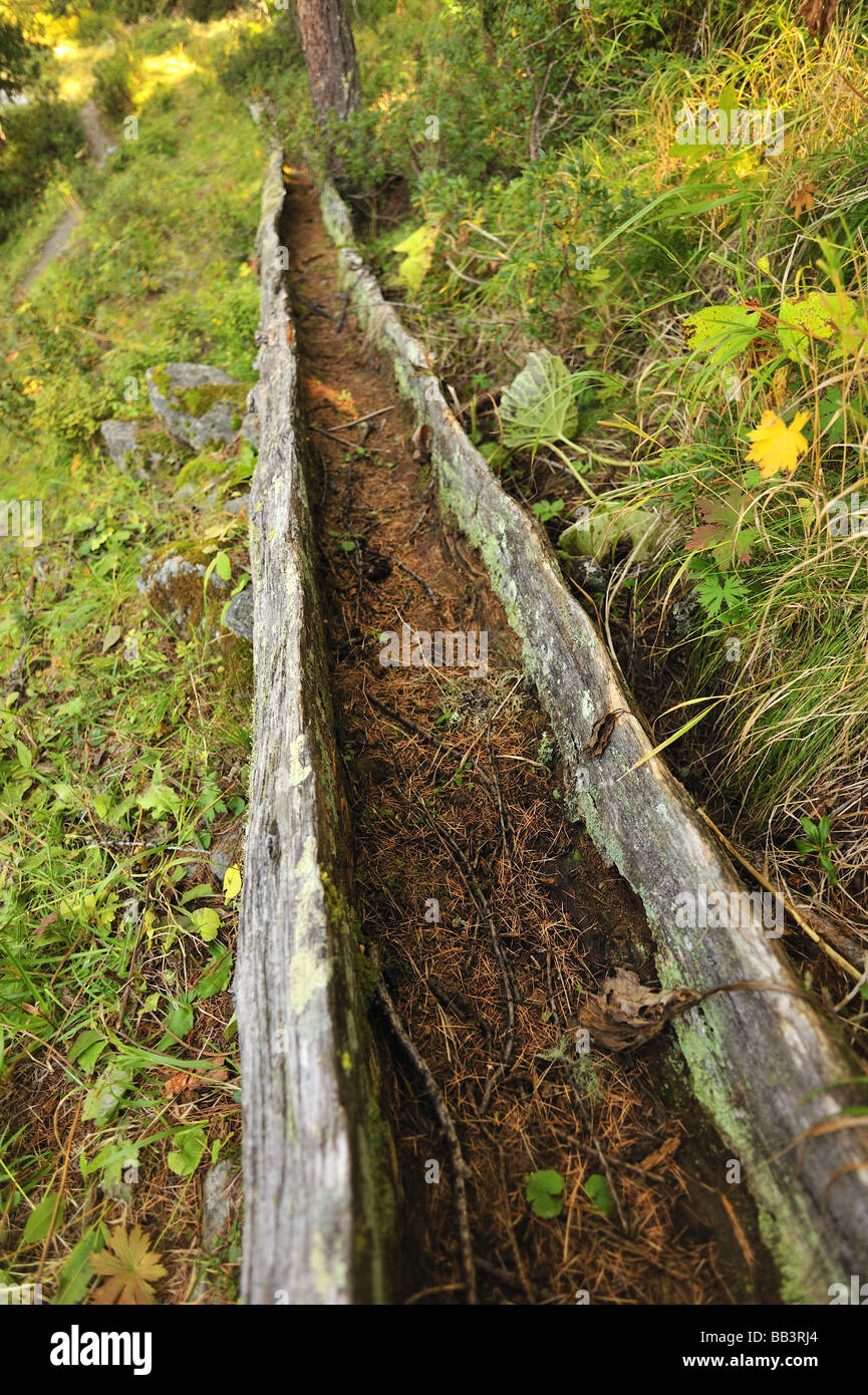 Part of a disused Swiss mountain irrigation system - a wooden trough called a bisse Stock Photo
