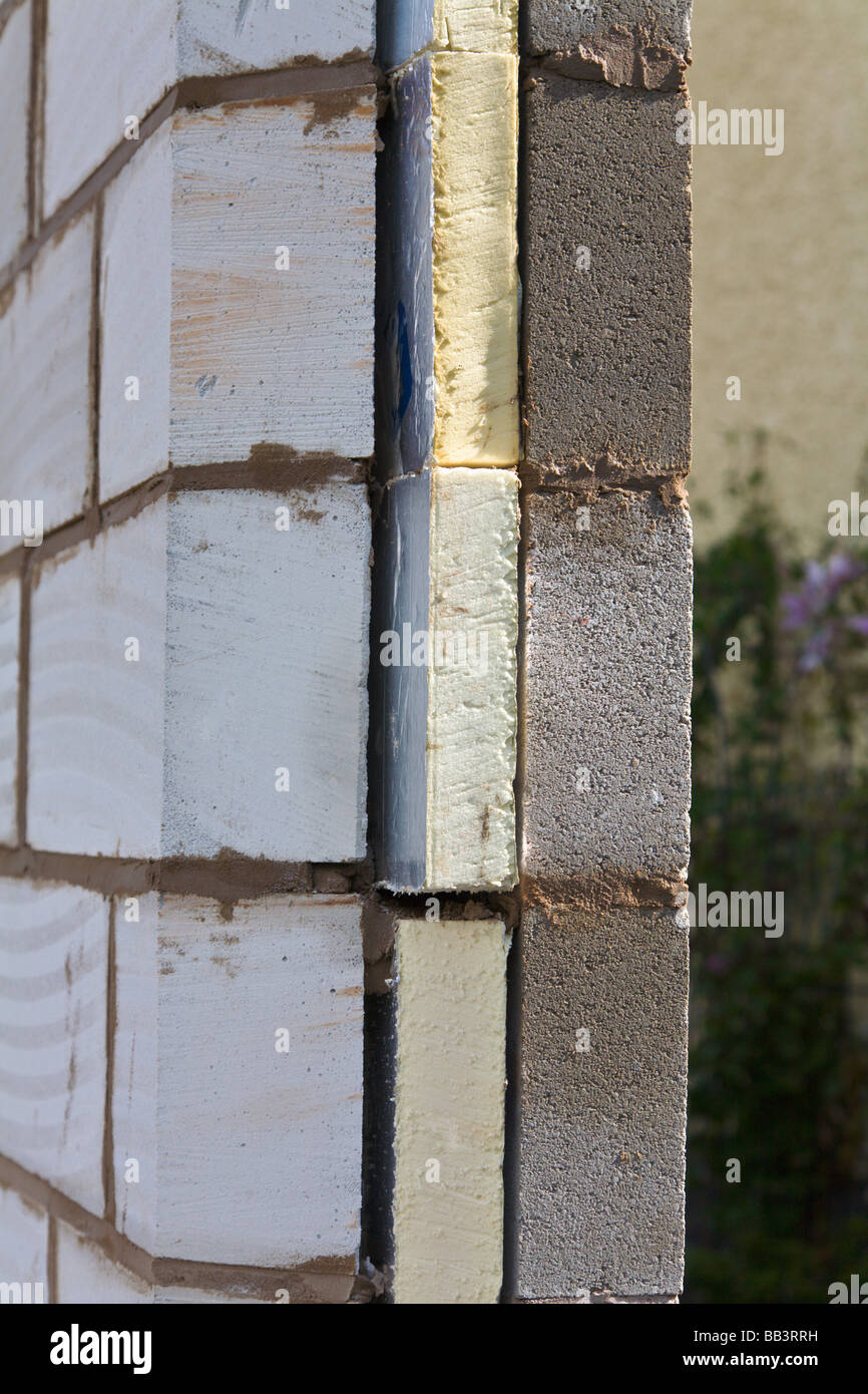 Cavity block built wall showing blocks of insulation Stock Photo