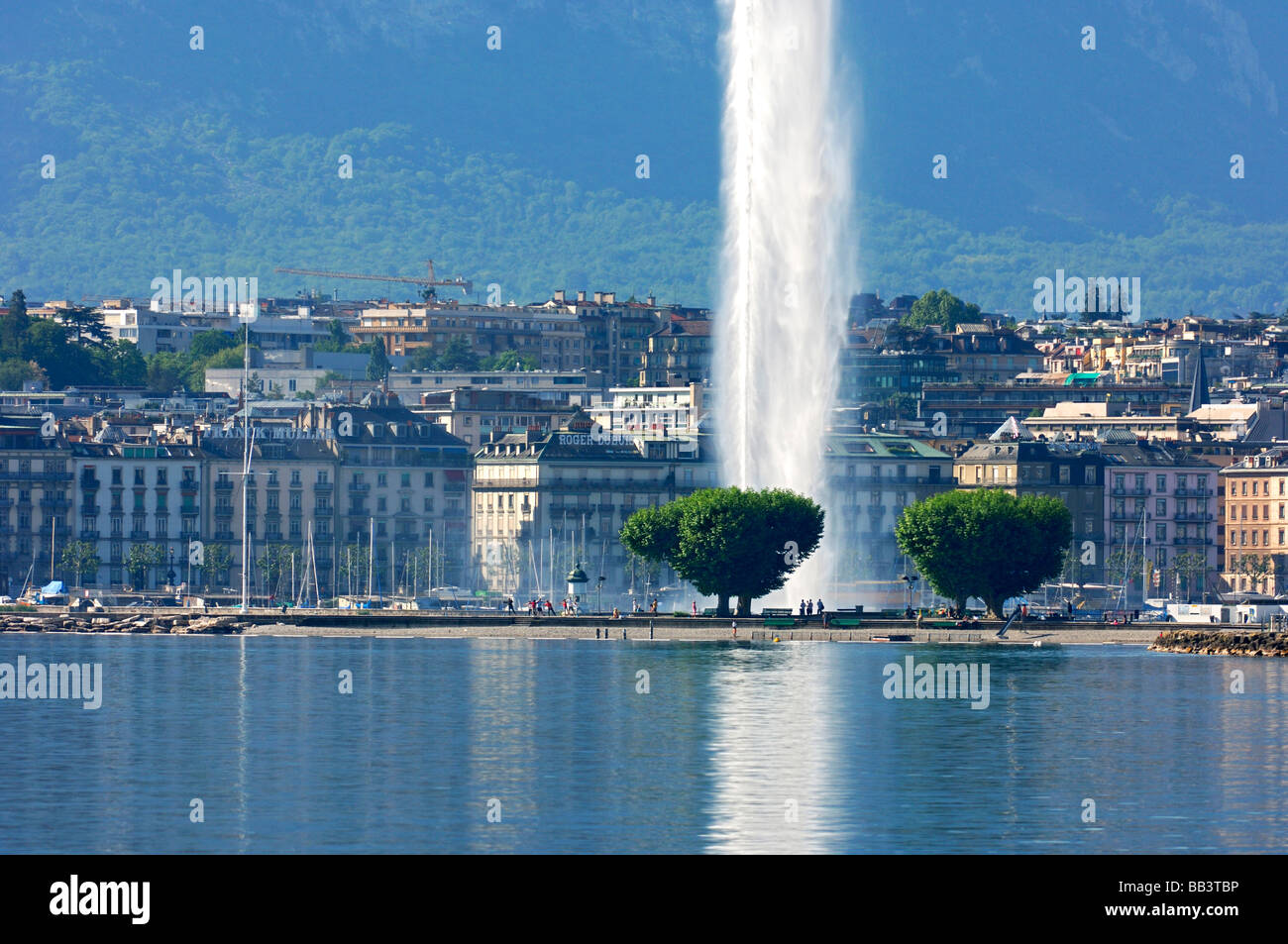 View across the Rade towards the old town of Geneva the water jet fountain Jet d Eau, Geneva, Switzerland Stock Photo