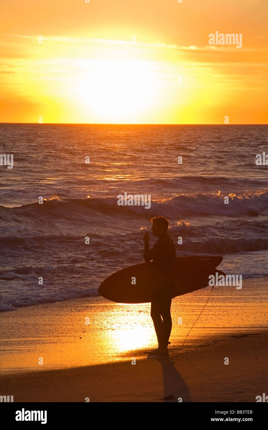 Surfer enjoying sunset at San Clemente Beach; San Clemente, California, USA Stock Photo
