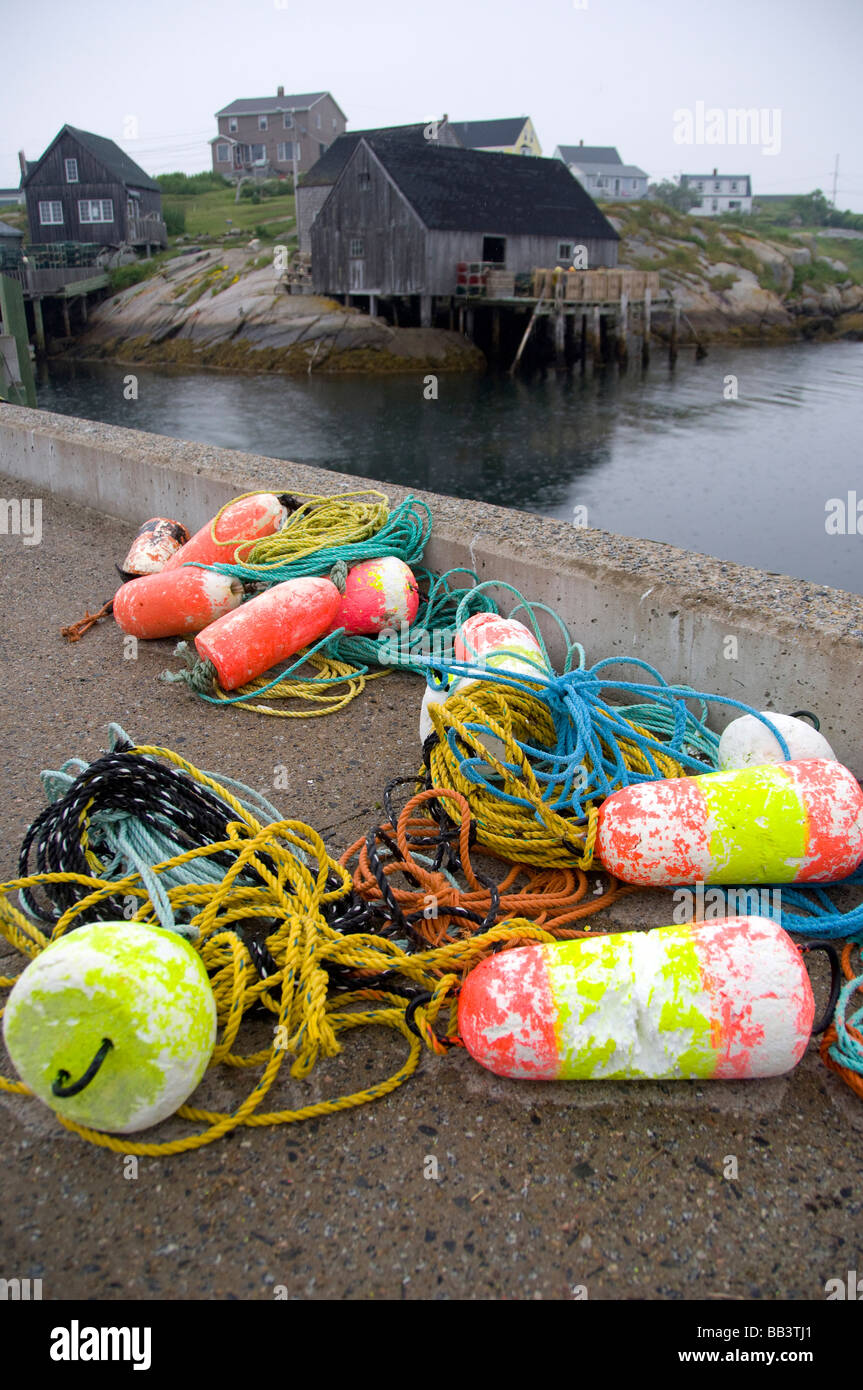 Canada, Nova Scotia, Peggy's Cove. Colorful lobster trap floats on dock