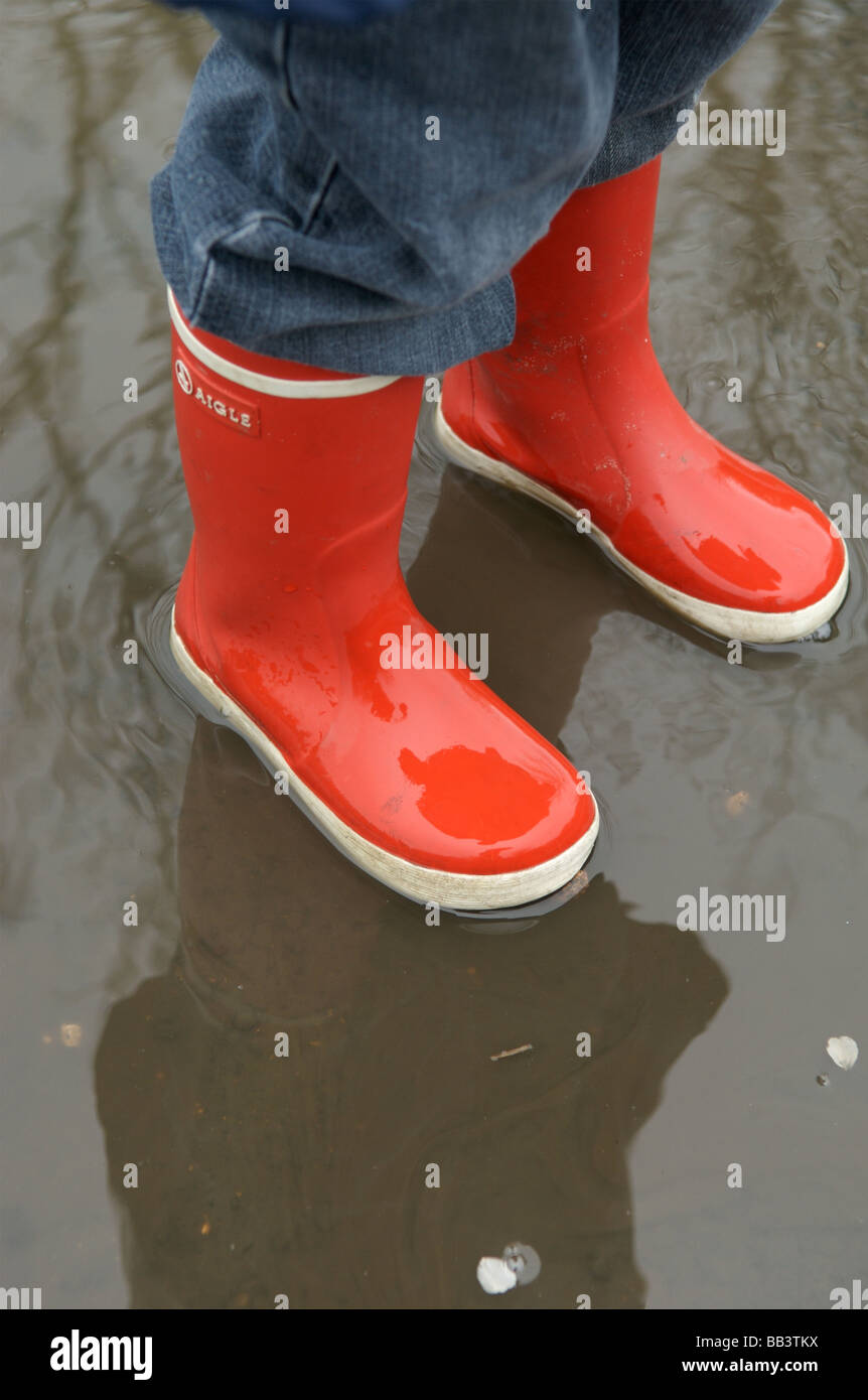 A young child in red wellington boots 