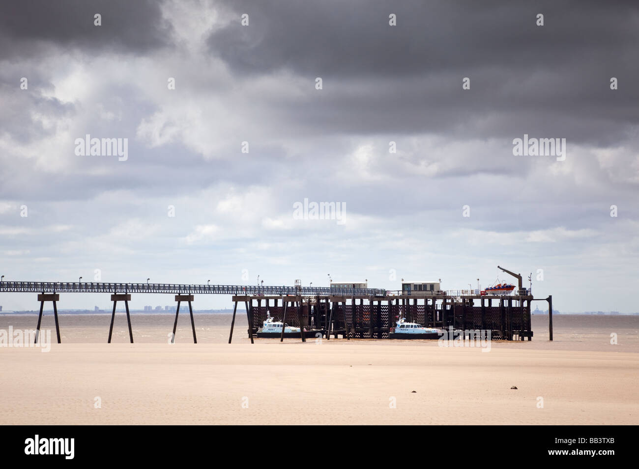 Jetty at Spurn Point East Yorkshire England UK with two Humber Estuary Pilot boats moored nearside and lifeboat beyond Stock Photo