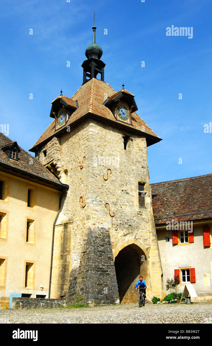 at the Romanesque abbey of Romainmotier, clock tower and entrance portal in the back, Romainmotier, canton of Vaud ,Switzerland Stock Photo