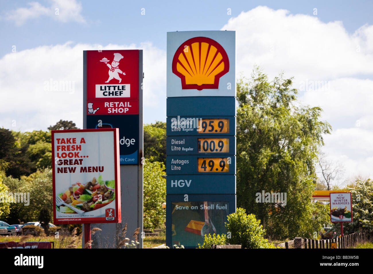 A road petrol prices with services signage England UK - 2009 Stock Photo